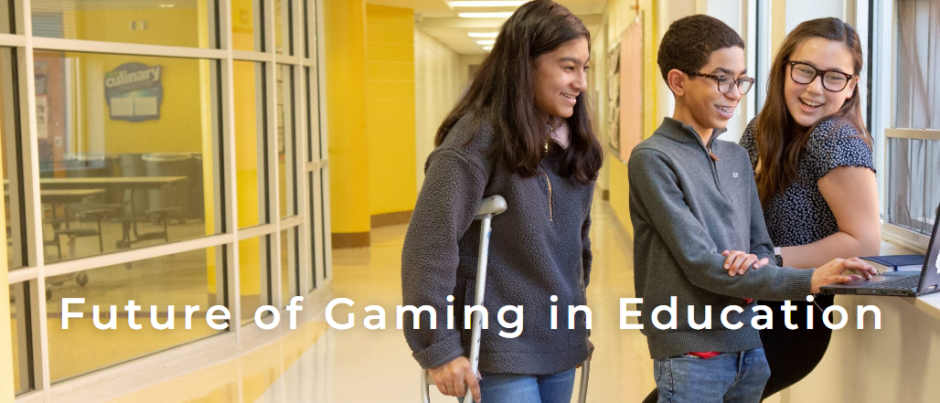 Three students standing around a laptop in a school corridor. Text - "Future of Gaming in Education"