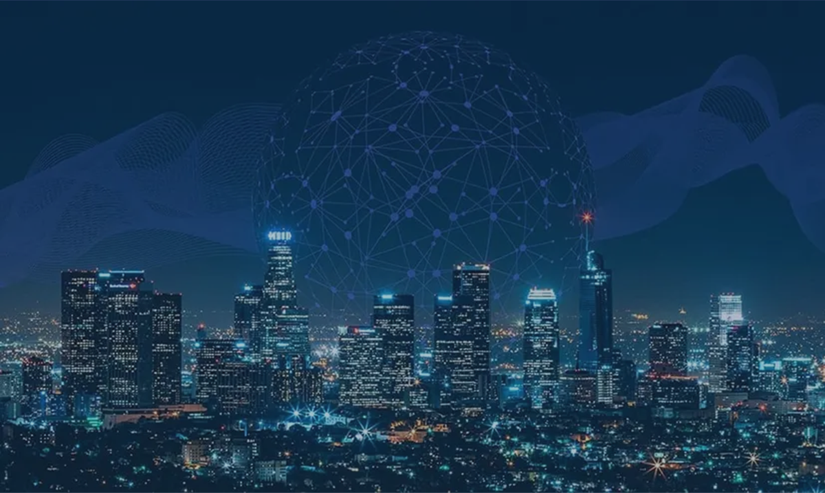 Male teacher helps two female students at computer